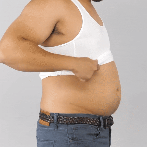 Man in white tank top pulling shirt up, revealing a protruding belly and blue jeans with a braided belt